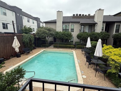 Community pool with a fenced backyard and a patio area