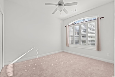 Empty room with carpet flooring and ceiling fan