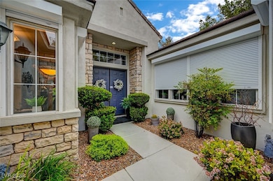 Entrance to property with stone siding and stucco