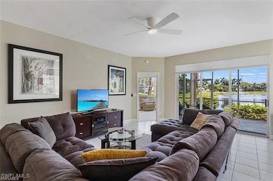 Living room featuring ceiling fan and light tile p