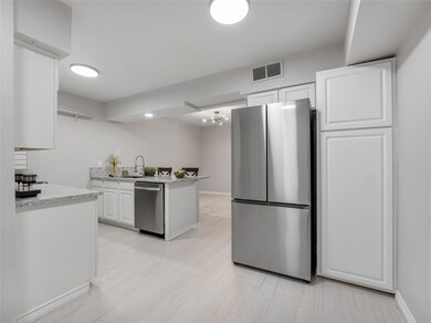Kitchen with light stone counters, light hardwood 
