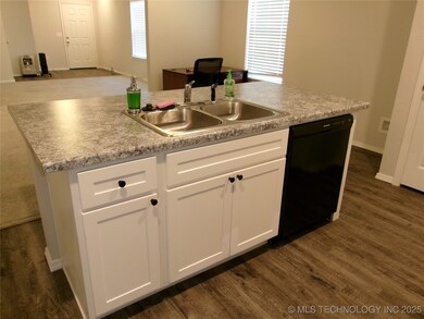 Kitchen featuring white cabinetry, dark wood finis
