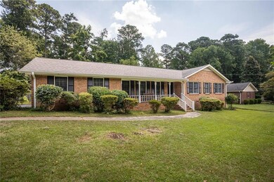Ranch-style home with brick siding and a front lawn