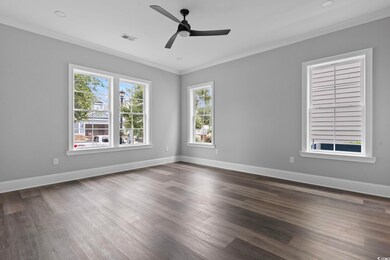 Unfurnished room with ceiling fan, dark hardwood /