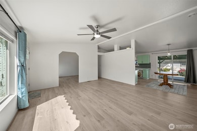 Living room looking towards dining room & kitchen to the right, and towards the office/den to the left.