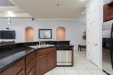 View of the kitchen work space for easy organization and traffic flow.  Notice the overhead and pendant lighting in this kitchen.  The two entries house the Master bedroom and the 4th bedroom that has its own bathroom.