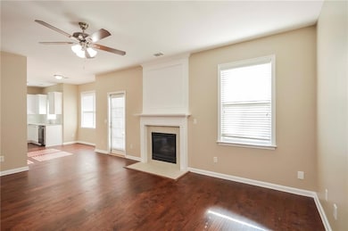 Unfurnished living room with a ceiling fan, a tile