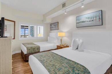 Bedroom with hardwood / wood-style flooring and tr