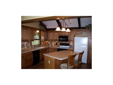 Cabinets galore, cathedral ceiling, tile floors an