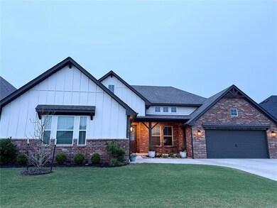View of front of house with brick siding, a front lawn, and a garage