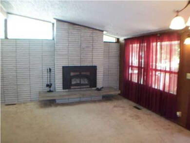 Living room with wood burning insert in fireplace