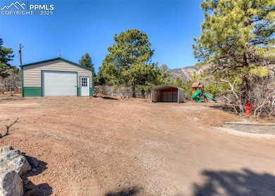 View of yard with an outdoor structure, a carport,