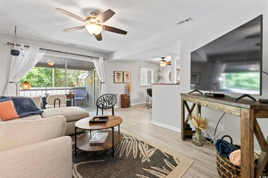 Living area with ceiling fan, a textured ceiling, 