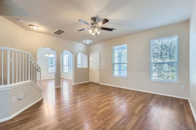 Foyer entrance with visible vents, wood finished 