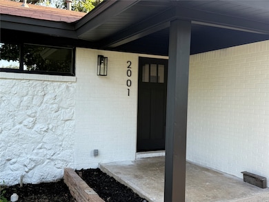 Property entrance featuring brick siding