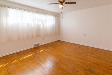 Bedroom1 Carpet removed to show hardwood that runs