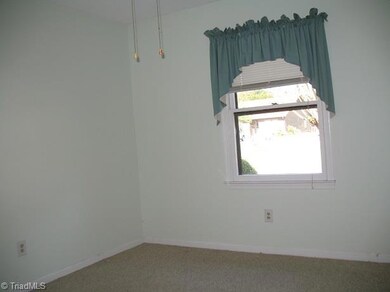 Rear Bedroom with window looking out at the woods.