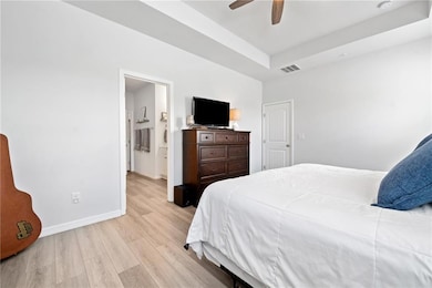 Bedroom featuring light wood-style flooring, baseb