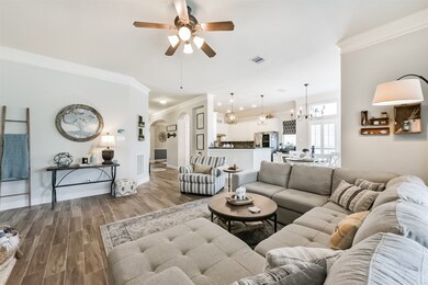 A family room featuring a ceiling fan with an inte