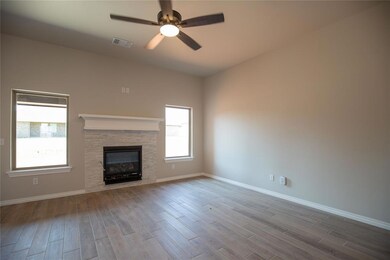 Unfurnished living room with ceiling fan, light ha