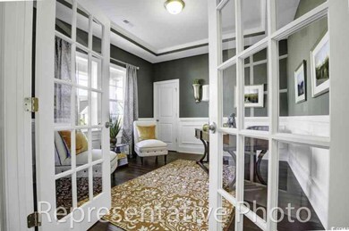 Office featuring french doors, wainscoting, and dark wood finished floors