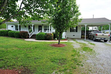 large covered front porch and two car carport