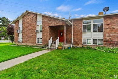 View of front of house featuring a front yard and brick siding