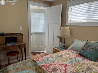 Bedroom with light wood-style floors and baseboards
