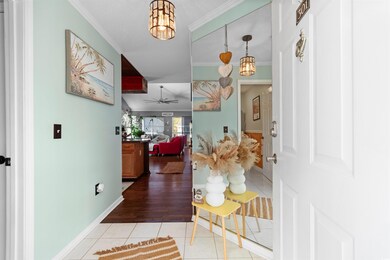 Foyer featuring ornamental molding, ceiling fan, b