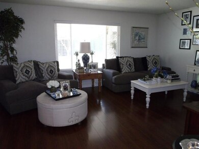 LIVING ROOM AS SEEN FROM ENTRY FOYER.