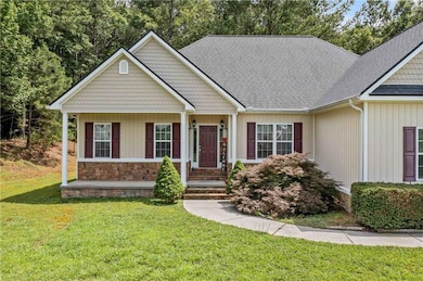 View of front of property featuring a front yard and roof with shingles