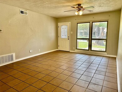 Foyer entrance featuring a textured wall, visible 