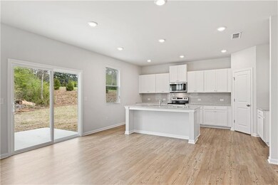 Kitchen featuring tasteful backsplash, light wood-