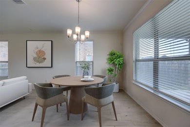 Dining space with a chandelier, crown molding, an