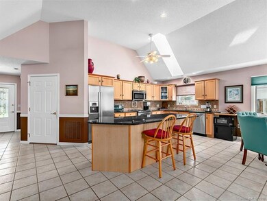 Large bright kitchen has stainless steel appliance