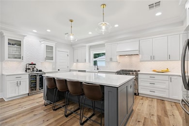 Well equipped kitchen with quartz counters and island seating.