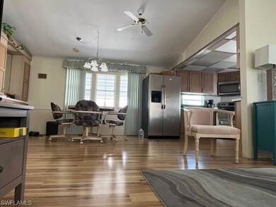 Dining space with ceiling fan with notable chandel