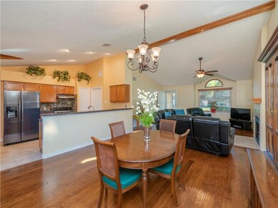 Dining room featuring lofted ceiling, a chandelie