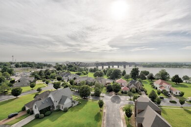 Aerial view of residential area with a notable bridge and a nearby body of water
