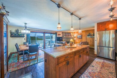 Kitchen with wooden walls, stainless steel refrige
