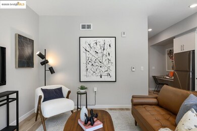 Living room with light wood finished floors and recessed lighting