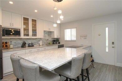 Kitchen with light stone countertops, appliances w
