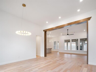 Unfurnished living room featuring ceiling fan with
