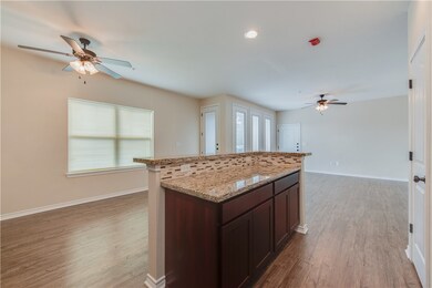 Kitchen featuring light wood-style flooring, baseb