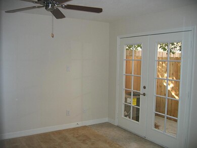 DOWNSTAIRS BEDROOM WITH FRENCH DOORS.