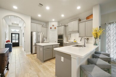 The kitchen counters are a white quartz and the br