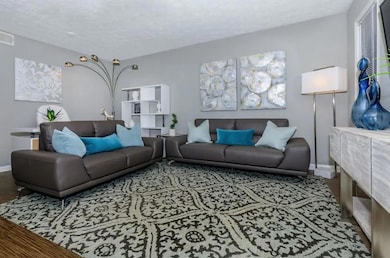 Living room with a textured ceiling and hardwood /