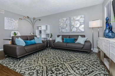 Living room with a textured ceiling and hardwood /