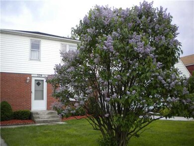 Exterior Front Lilacs in bloom