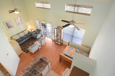 Living room with a towering ceiling, hardwood / wo